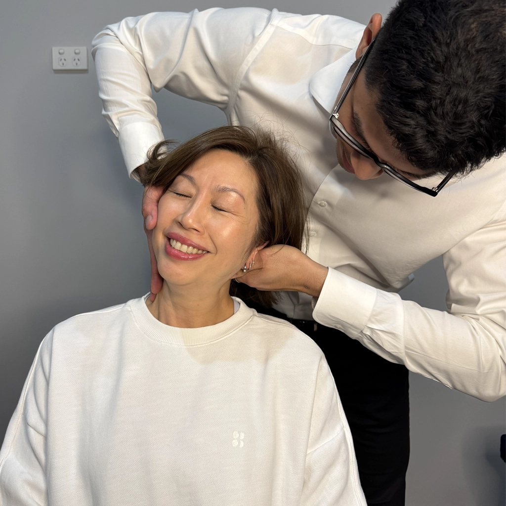 Chiropractor in Ringwood clinic performing a seated neck adjustment using the Gonstead technique