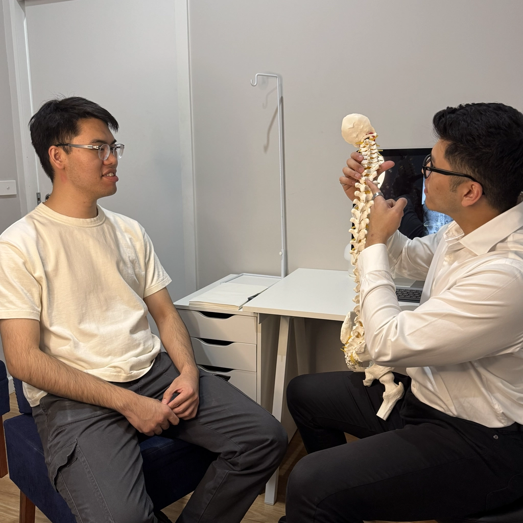 Ringwood chiropractic practitioner using a spine model and x-ray to explain misalignments and treatment plan